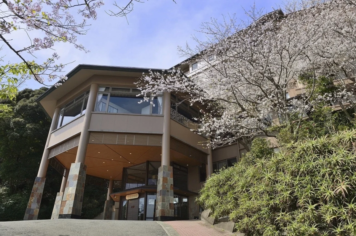 桜と建物に囲まれた吉祥ＣＡＲＥＮの外観